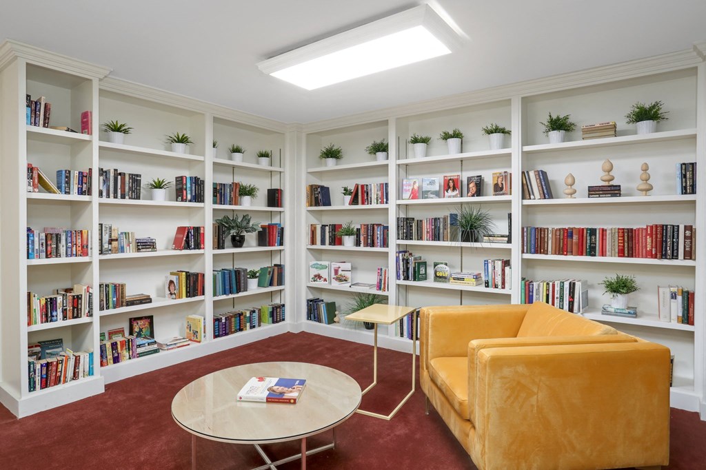 a library with a couch and a table