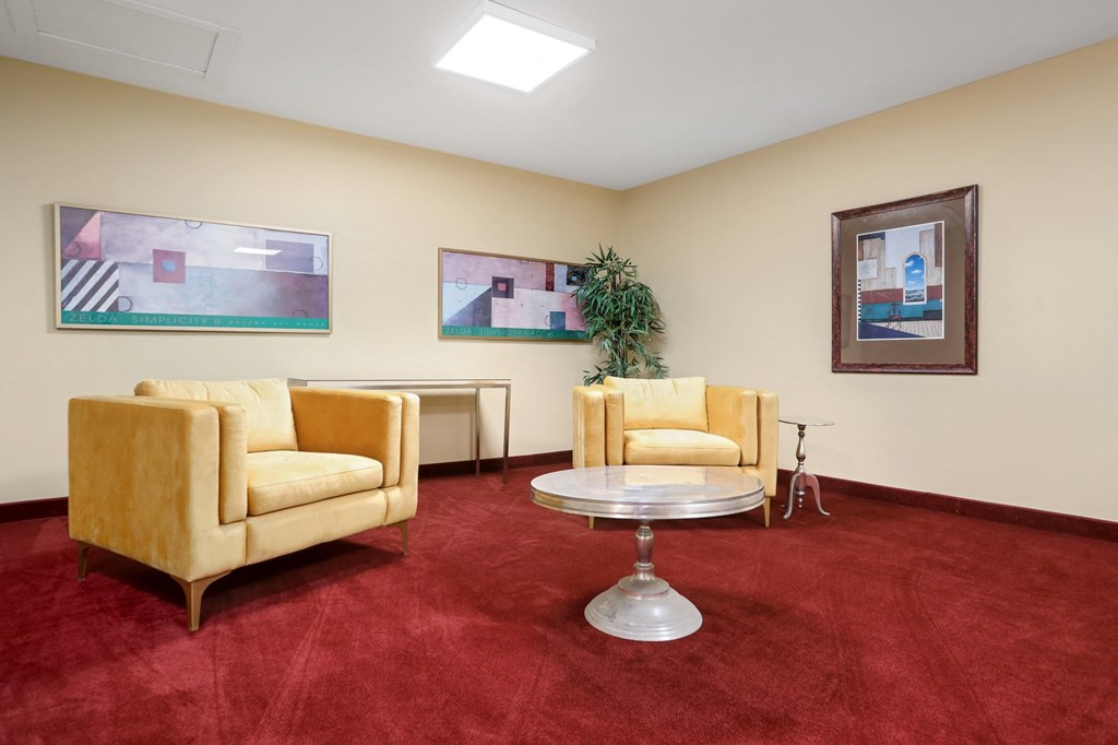 a living room with two yellow couches and a table