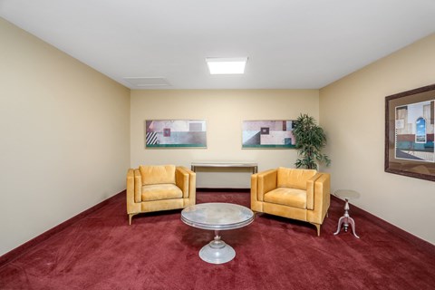 a living room with two yellow chairs and a table