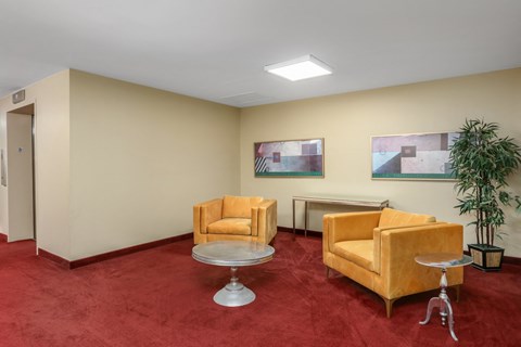 a living room with two yellow chairs and a table