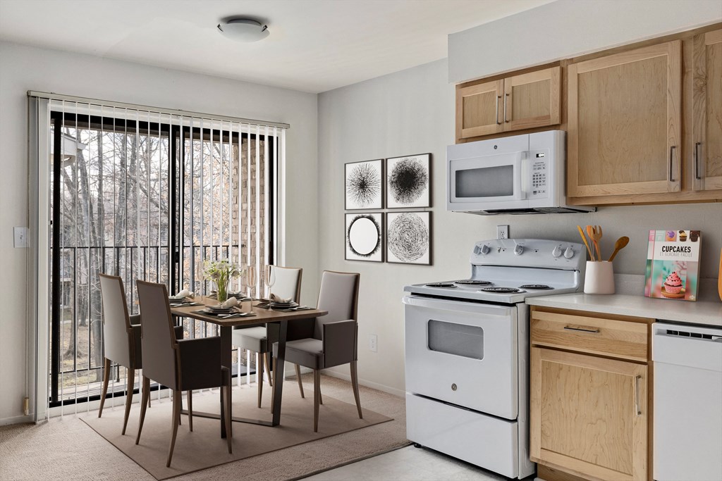 a kitchen and dining room with a white stove and microwave and a table and chairs