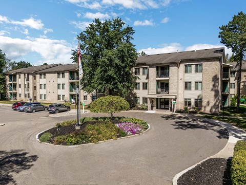 an empty parking lot in front of an apartment building