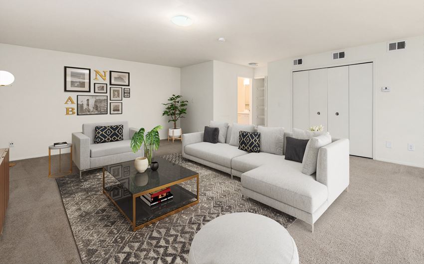 a living room with white couches and a coffee table