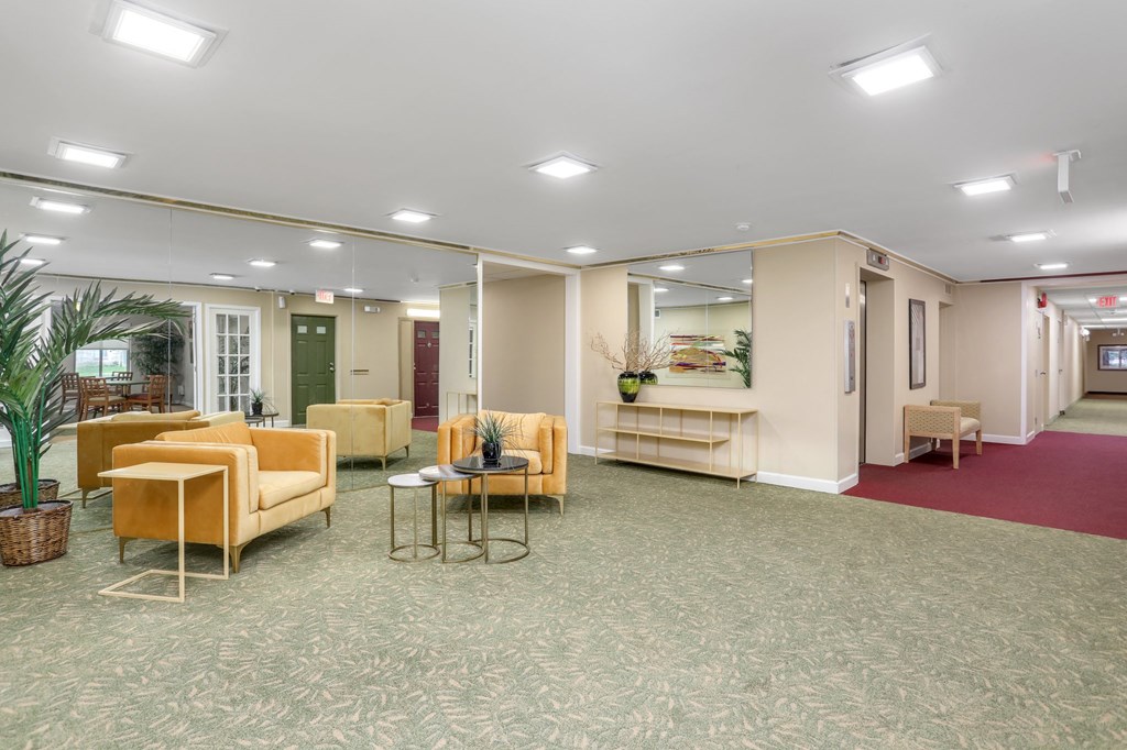 a lobby with couches and chairs and a table