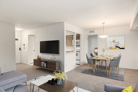 a living room and dining room with a table and chairs and a television