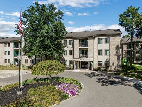an apartment building with an flag in front of it