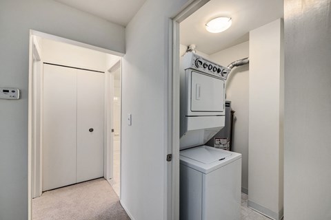 the laundry room has a washer and dryer and a door to the closet