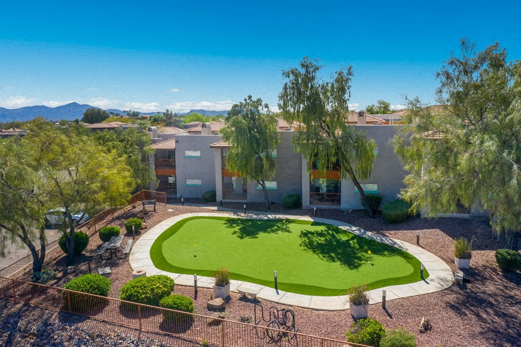 a circular lawn in the middle of a house with a courtyard