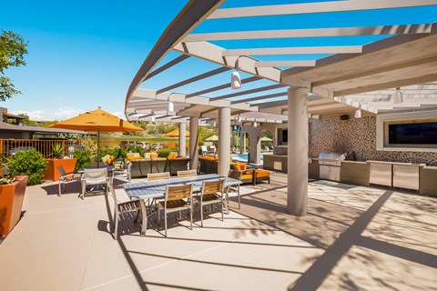 a patio with tables and chairs and umbrellas