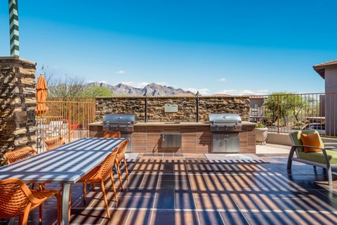the patio has a grill and a table with chairs
