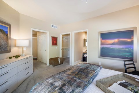 a bedroom with a bed and a dresser and a window