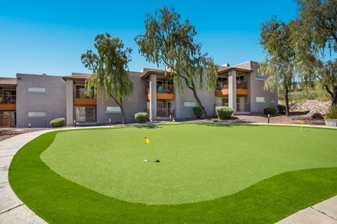 a putting green in front of an apartment building