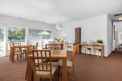 the dining room and living room of a house with a large table and chairs
