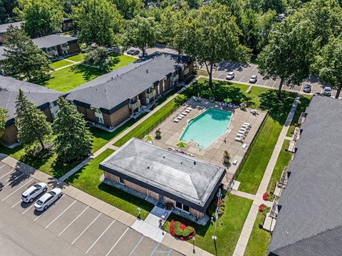 an overhead view of a parking lot and a swimming pool