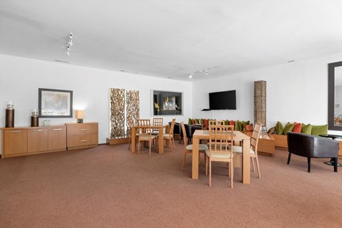 a living room with a table and chairs and a television