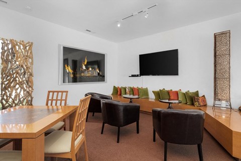 a living room with a table and chairs and a fireplace