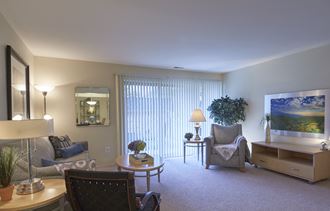 a living room filled with furniture and a large window