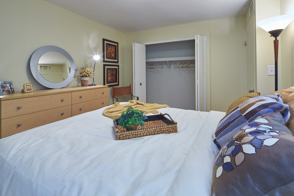 a bedroom with a white bed and a basket of fruit on it