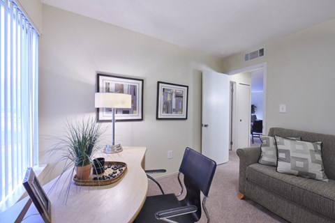 a living room with a table and a couch and a window