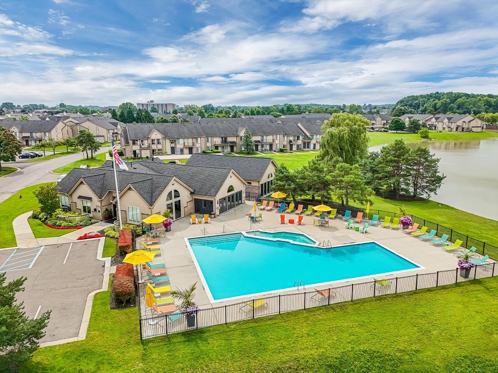 an aerial view of a swimming pool at the resort with a lake
