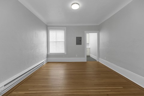 A room with wooden floors and white walls.
