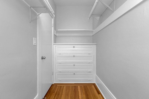 A white door with a white cabinet above it.