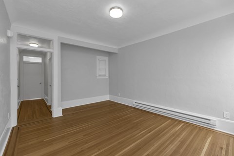 A room with wooden floors and white walls.