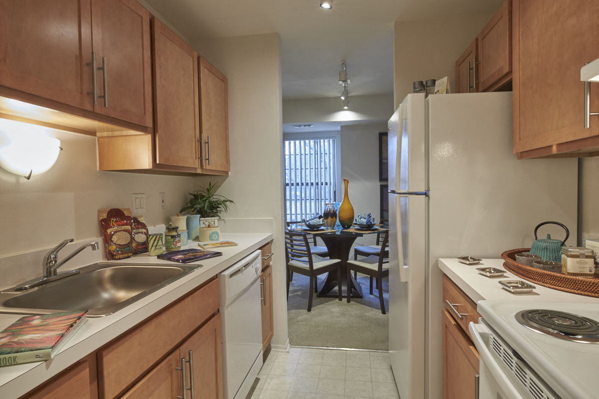A kitchen with wooden cabinets and a white refrigerator.