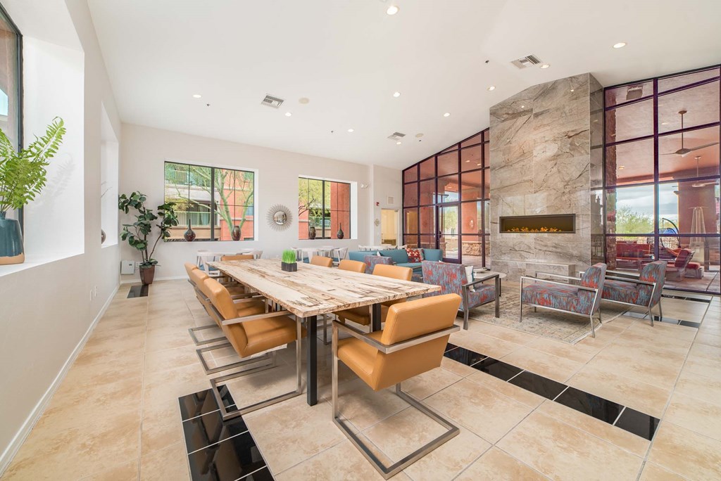 a dining room with a large table and chairs and a fireplace