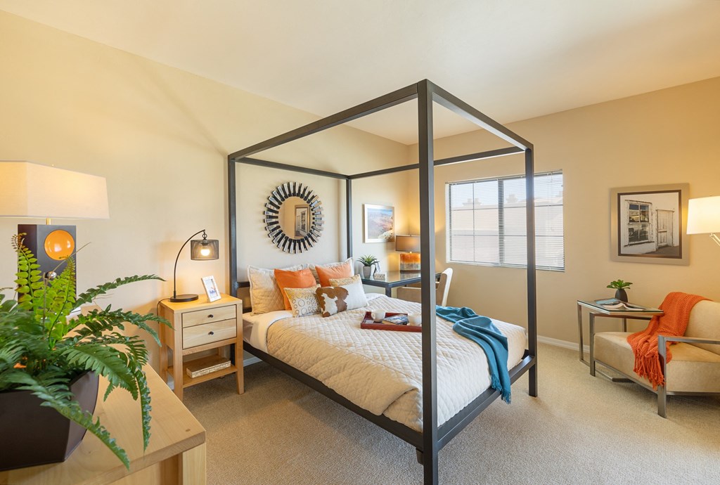 a bedroom with a large bed and a large window