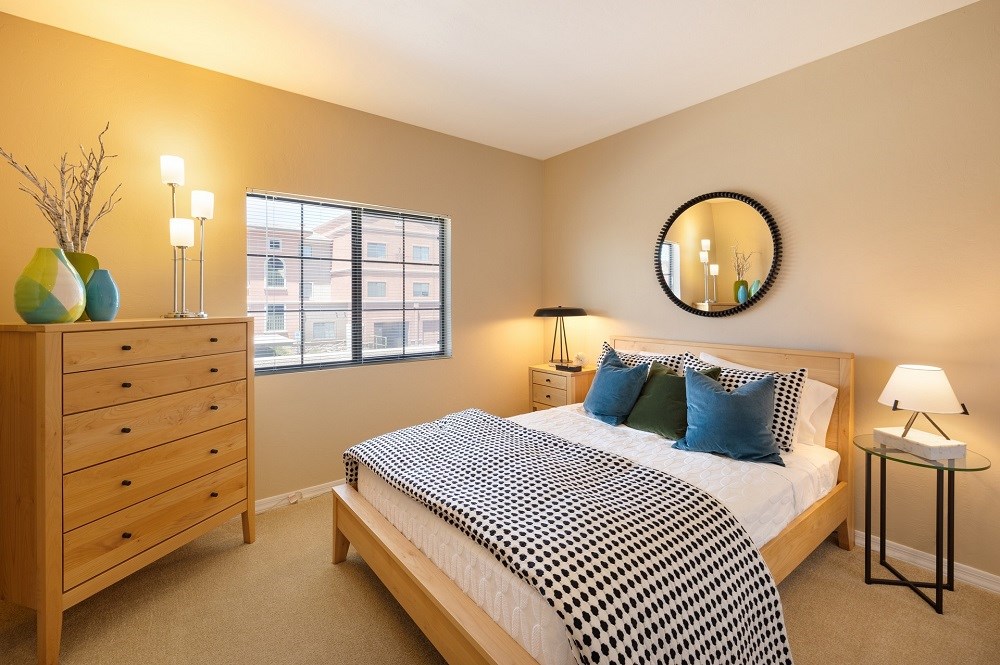 a bedroom with a bed and a dresser