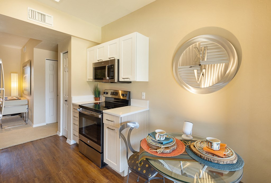 a kitchen and dining room with a glass table