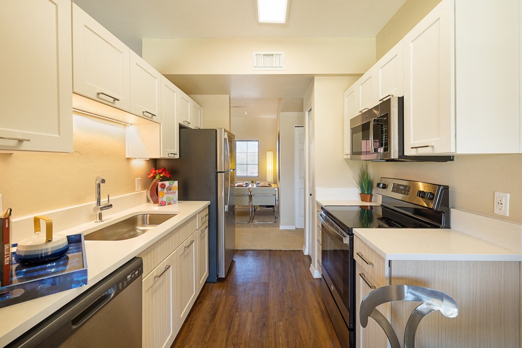 a kitchen with stainless steel appliances and white cabinets