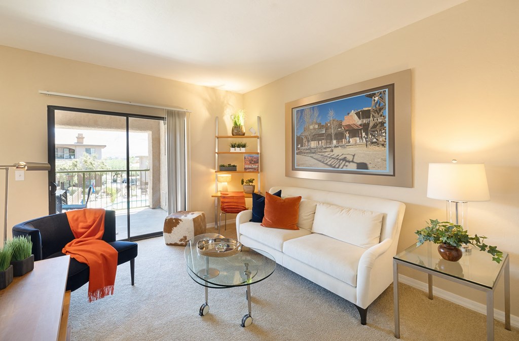 a living room with a white couch and a glass table