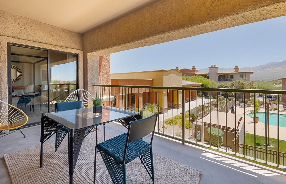 a patio with a table and chairs on a balcony