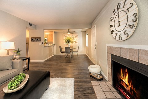 Citrus Heights, CA Apartments for Rent-The Reva-Living Room with Vinyl Flooring, a Fireplace, Central Heating and Air, and a Ceiling Fan