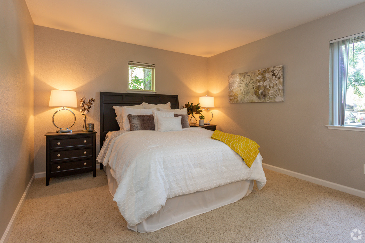 A bedroom with a large bed and a window.