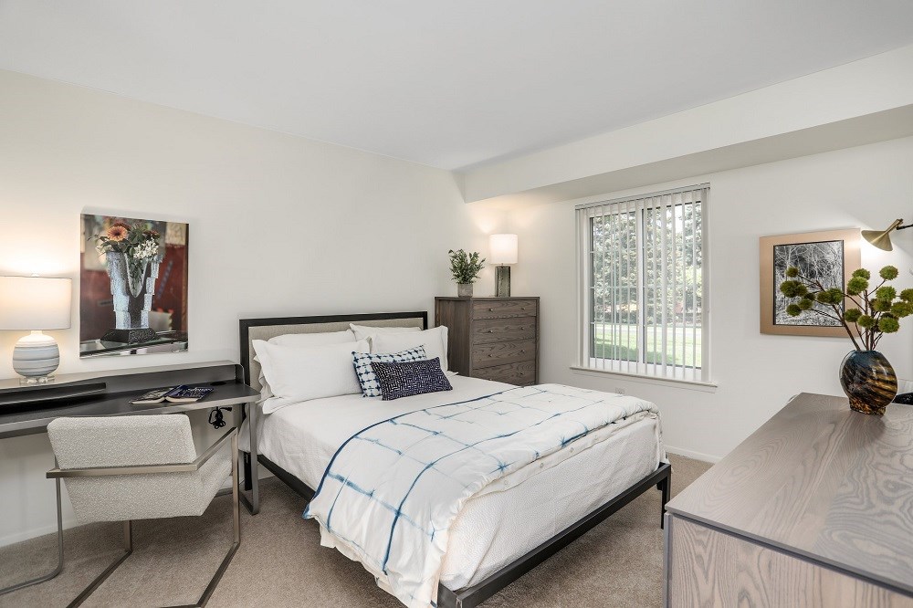 a bedroom with a bed and a desk with a chair