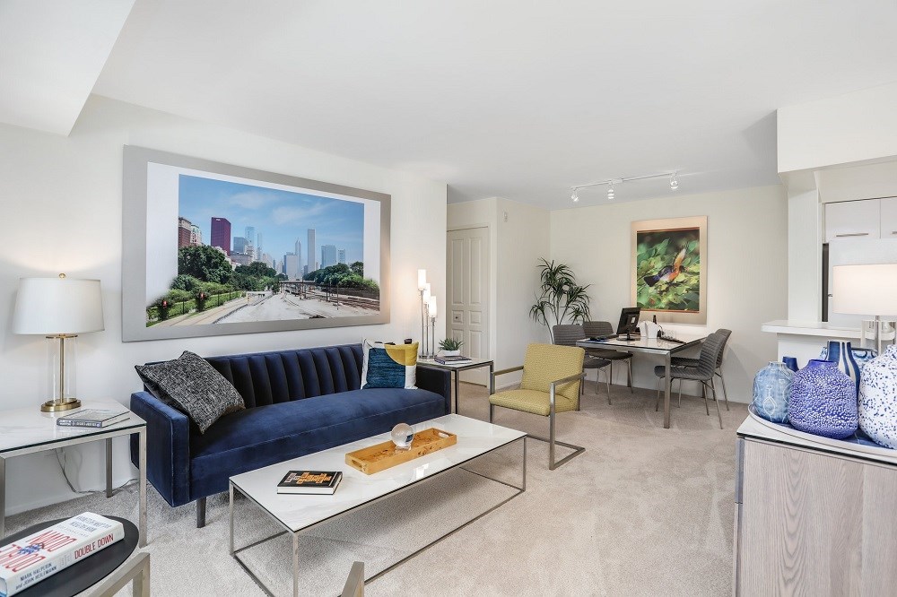 a living room with a blue couch and a white table