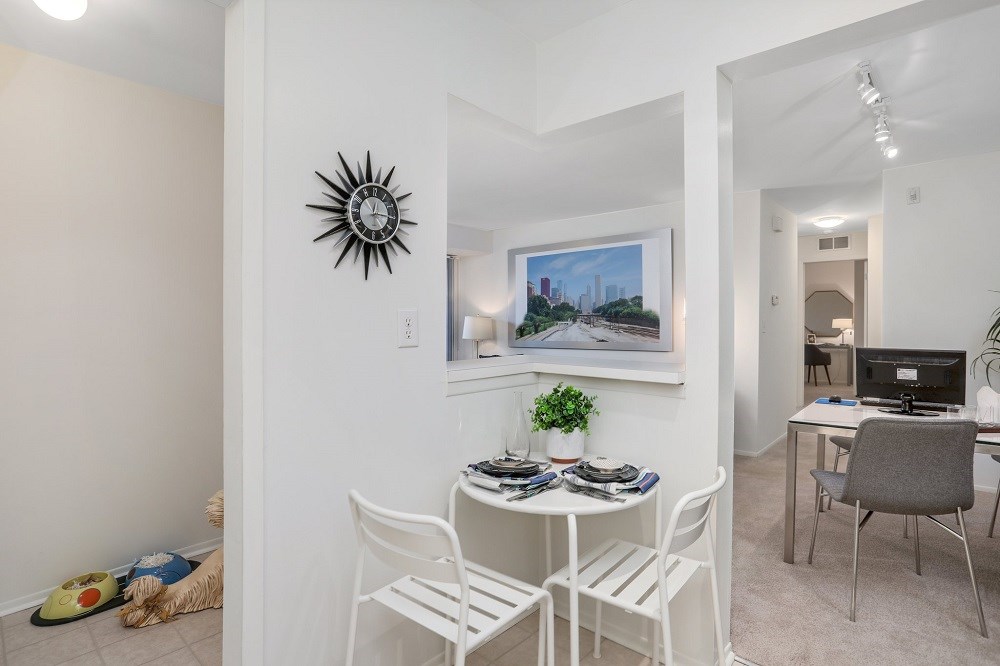 a living room and dining room with a table and chairs