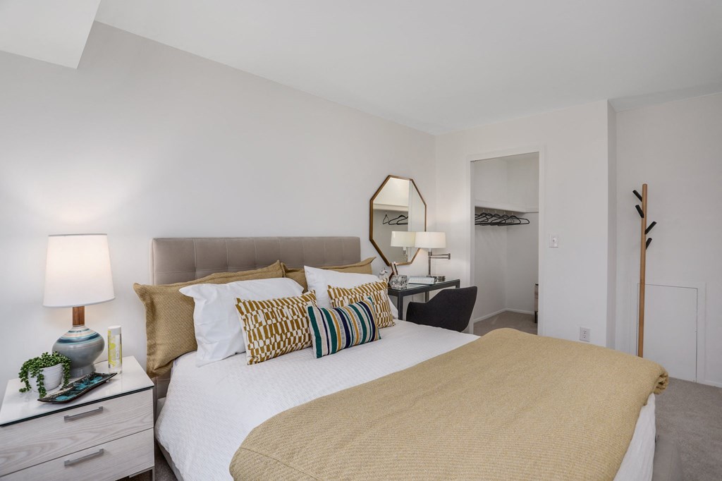 a bedroom with a large bed and a desk