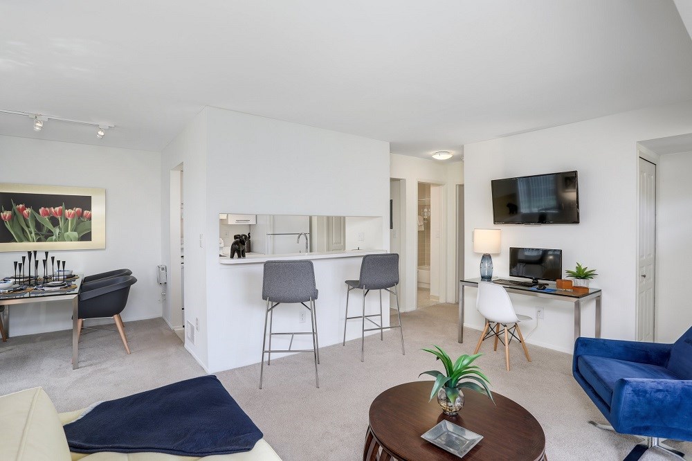 a living room with a kitchen and a dining room