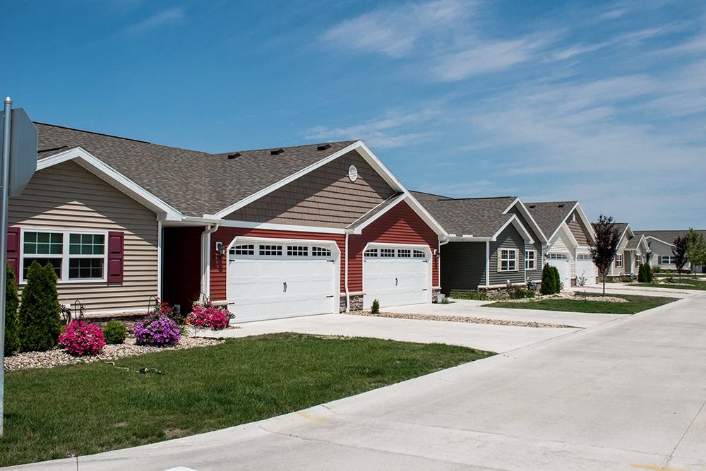 a row of houses with garage doors on a street