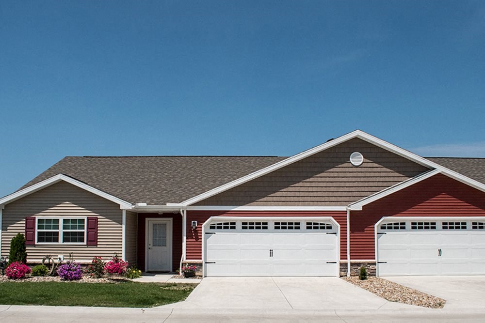 a red house with a white garage door