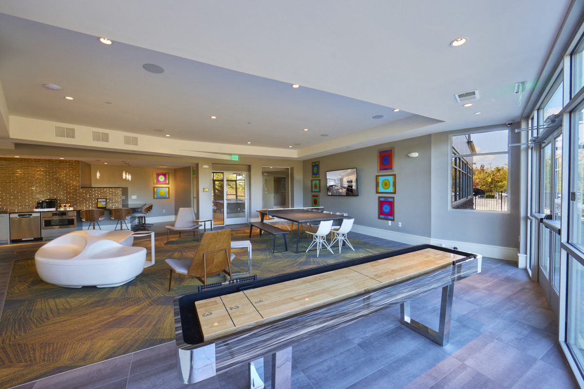 a large living room with a ping pong table
