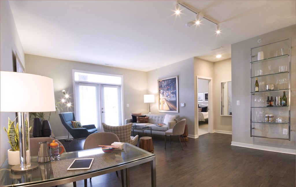a living room with couches and chairs and a dining room table