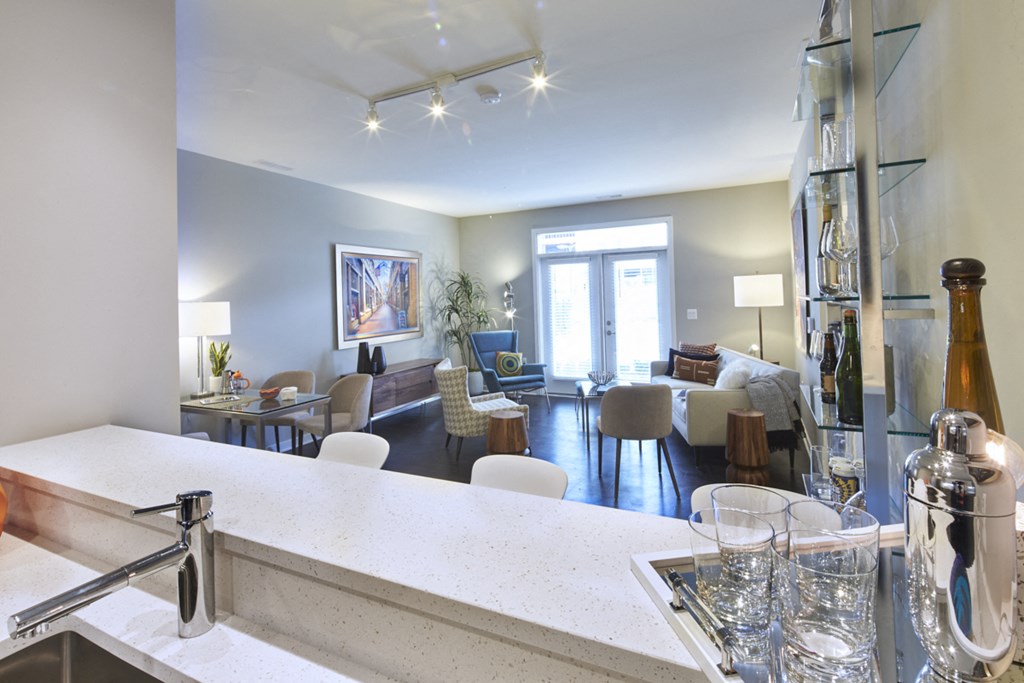 a view of a living room and a kitchen with a counter top