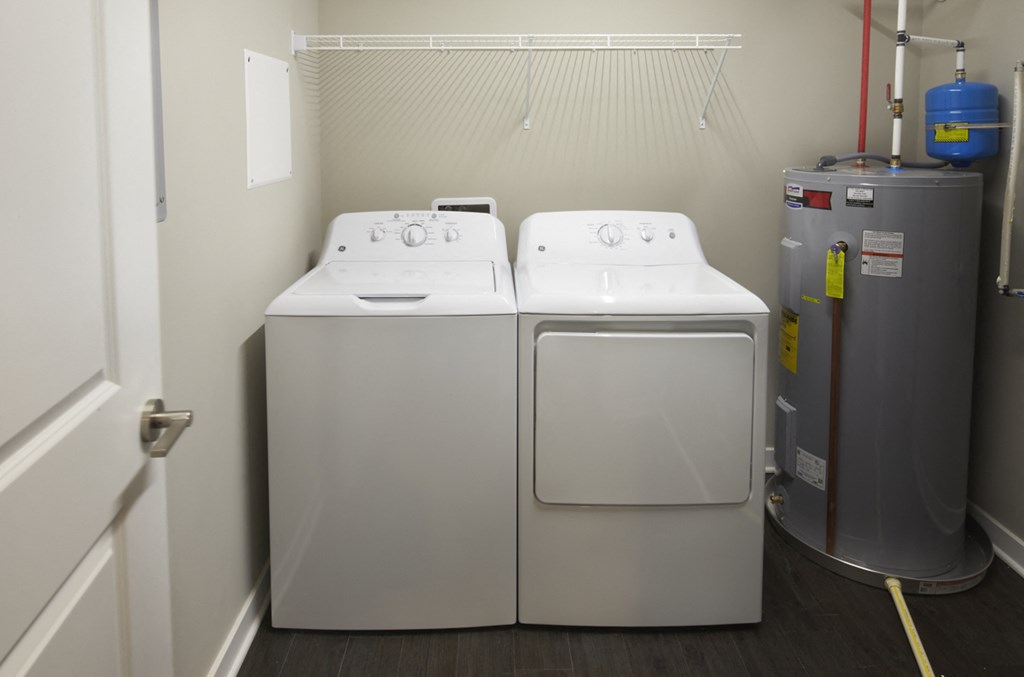 a washer and dryer in a room with a water heater