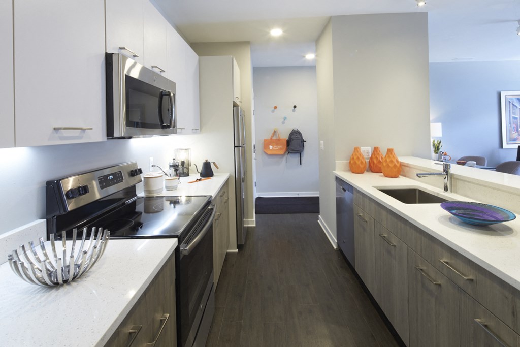 a kitchen with stainless steel appliances and white counter tops
