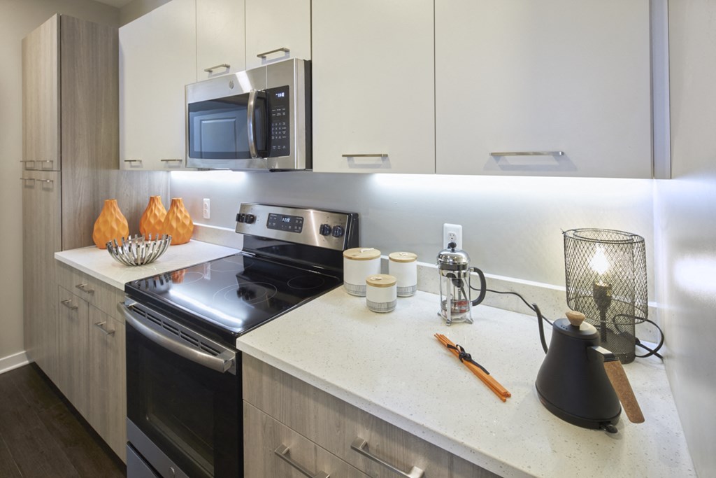 a kitchen with stainless steel appliances and a white counter top